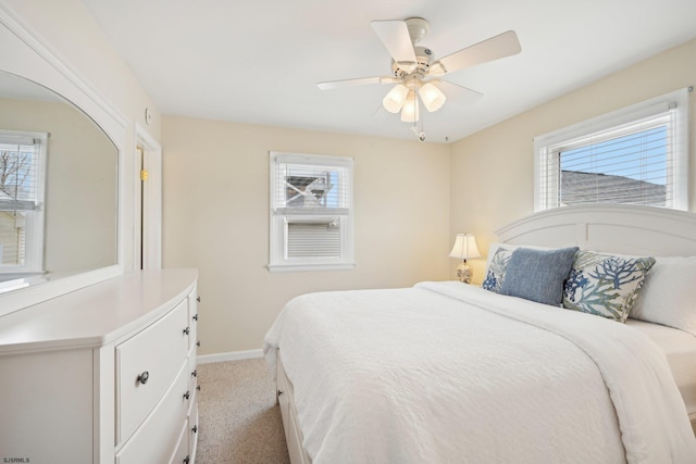 bedroom featuring baseboards, ceiling fan, and light carpet