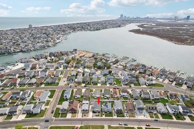 drone / aerial view featuring a water view and a residential view