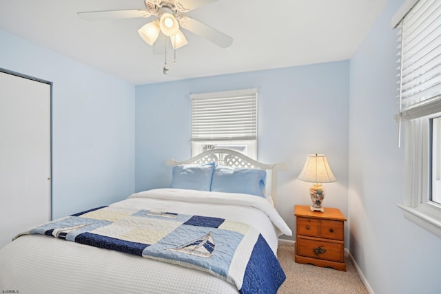 carpeted bedroom with baseboards and ceiling fan
