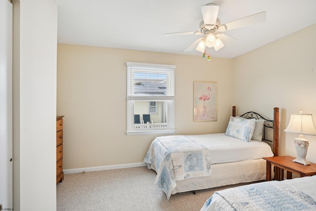 carpeted bedroom with baseboards and ceiling fan