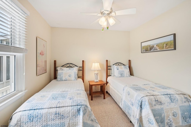 bedroom featuring carpet floors, a ceiling fan, and multiple windows