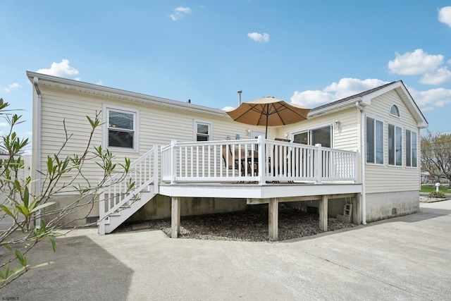 rear view of house with crawl space and a wooden deck