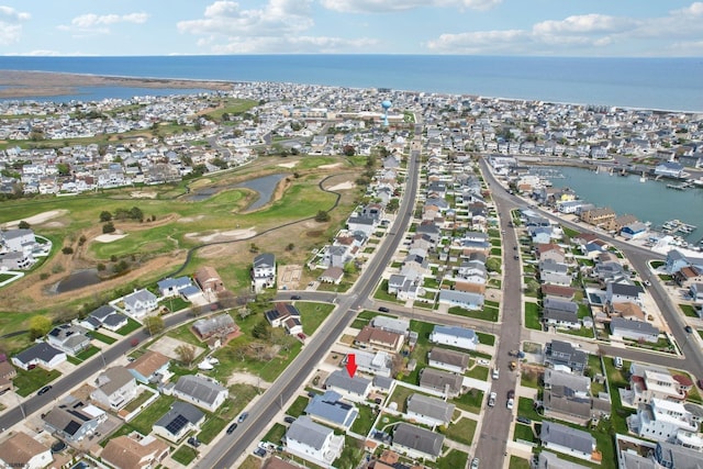 birds eye view of property featuring a water view, view of golf course, and a residential view