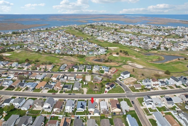 birds eye view of property with a residential view, a water view, and golf course view
