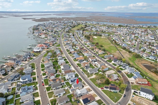 birds eye view of property with a water view and a residential view