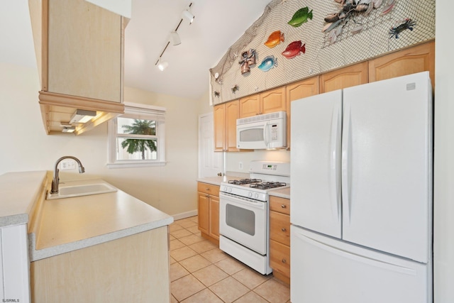 kitchen featuring light brown cabinetry, light tile patterned flooring, white appliances, rail lighting, and a sink