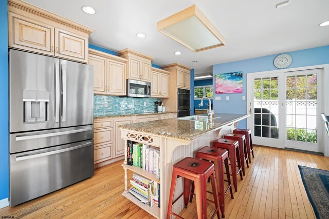 104 Van Sant Ave, Linwood, NJ 08221 - kitchen featuring tasteful backsplash, a sink, stainless steel appliances, light wood-style flooring, and cream cabinetry