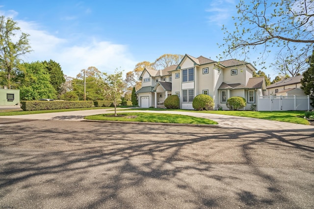 104 Van Sant Ave, Linwood, NJ 08221 - view of front of house with fence, curved driveway, a garage, and a front yard