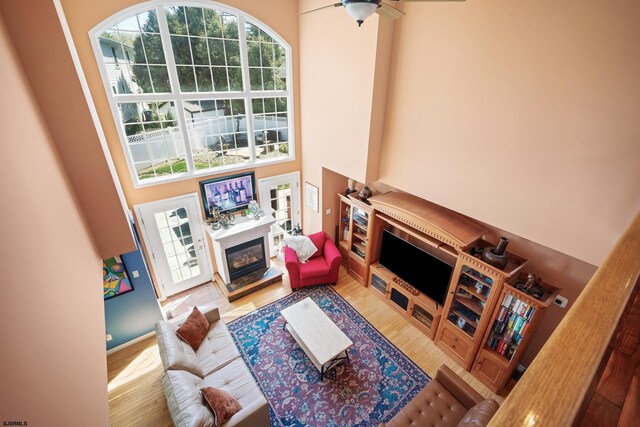 104 Van Sant Ave, Linwood, NJ 08221 - living area with a ceiling fan, a glass covered fireplace, wood finished floors, and a towering ceiling
