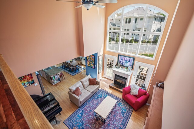 104 Van Sant Ave, Linwood, NJ 08221 - living area featuring a ceiling fan, a glass covered fireplace, wood finished floors, and a towering ceiling