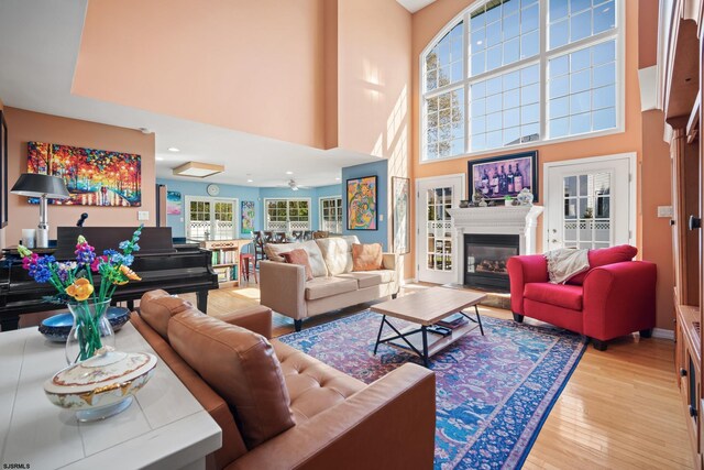 104 Van Sant Ave, Linwood, NJ 08221 - living room featuring light wood-type flooring, a glass covered fireplace, and a high ceiling