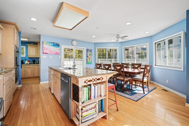 104 Van Sant Ave, Linwood, NJ 08221 - kitchen featuring appliances with stainless steel finishes, a sink, light wood-style floors, an island with sink, and baseboards