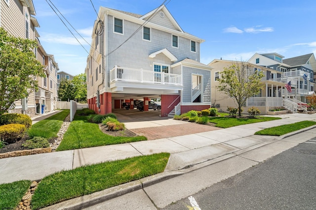 111 N Madison Ave Unit 2, Margate, NJ 08402 - view of front of property featuring stairway, decorative driveway, a residential view, and a carport