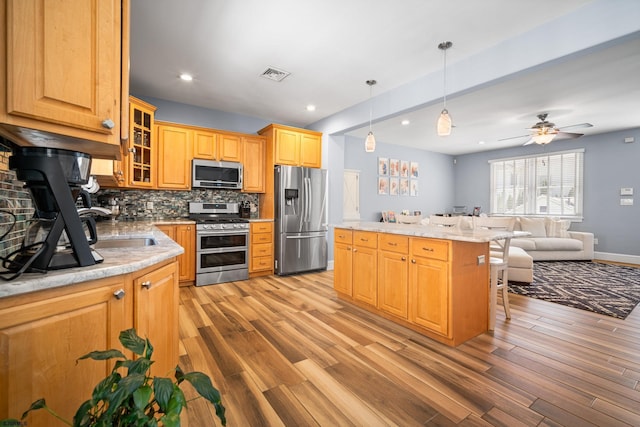 111 N Madison Ave Unit 2, Margate, NJ 08402 - kitchen with visible vents, light wood-type flooring, tasteful backsplash, and stainless steel appliances