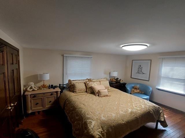 bedroom with dark wood-style floors