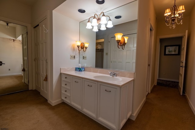 bathroom featuring baseboards, a notable chandelier, a closet, and vanity