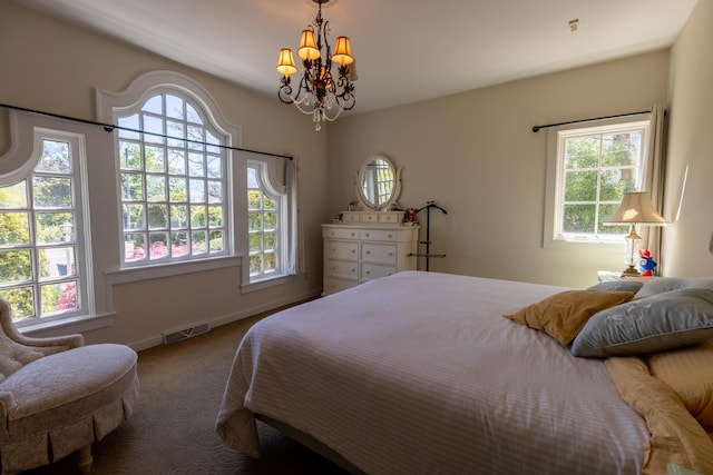 bedroom featuring visible vents, carpet flooring, multiple windows, and an inviting chandelier