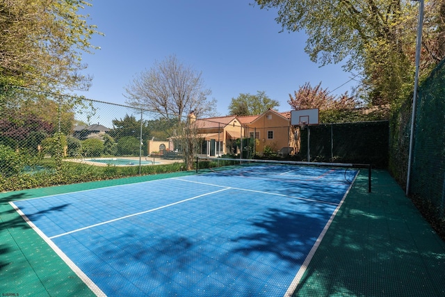view of tennis court with fence