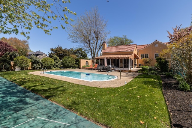 pool featuring a yard and a patio area