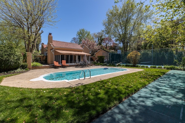 view of pool with fence, a fenced in pool, a patio, and a yard