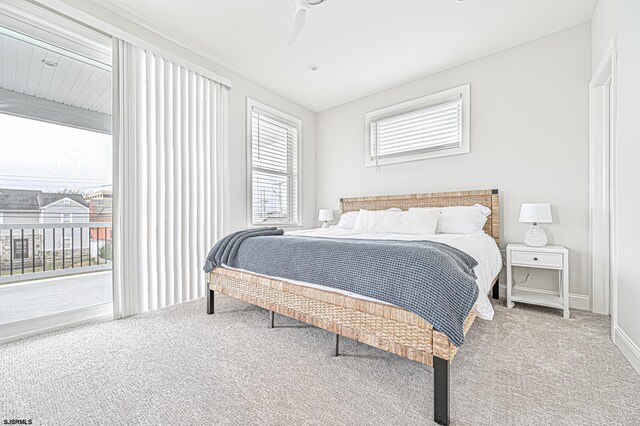 bedroom with carpet floors, a ceiling fan, baseboards, and access to exterior