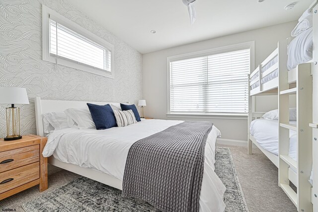 bedroom featuring carpet flooring, wallpapered walls, and baseboards