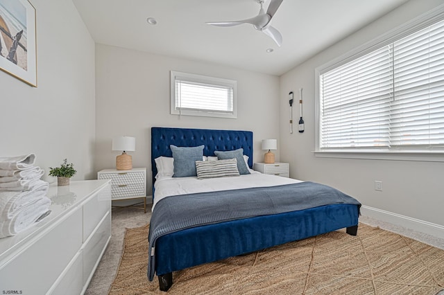 carpeted bedroom with baseboards and ceiling fan