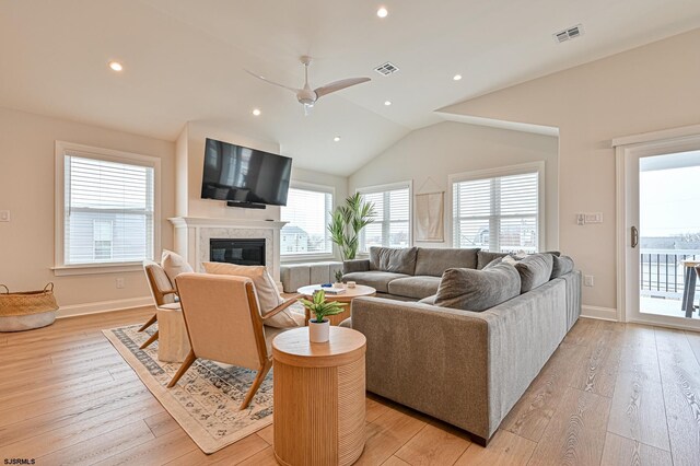living room with visible vents, a ceiling fan, and light wood-style floors