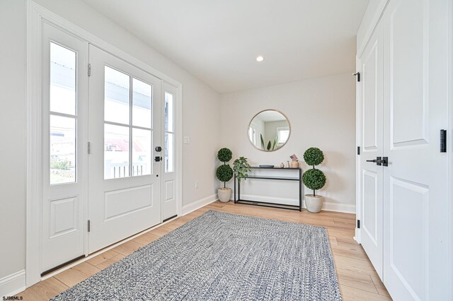entrance foyer with baseboards, recessed lighting, and light wood-style flooring