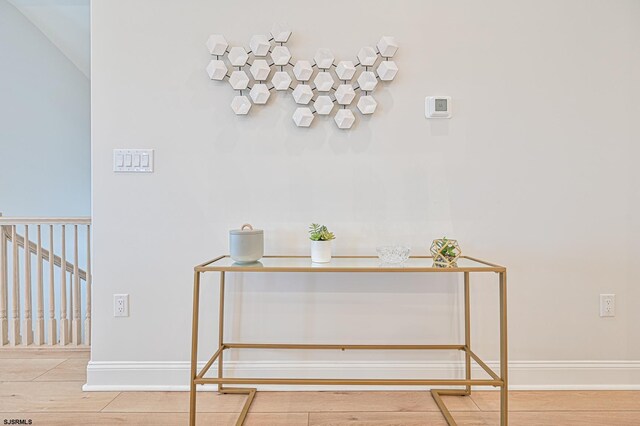 interior details with baseboards and wood finished floors