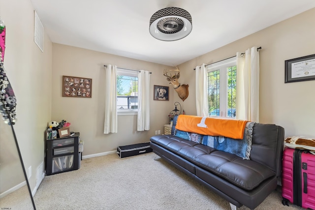 carpeted living room with baseboards and visible vents