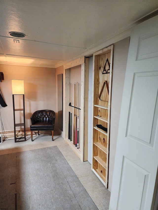 sitting room featuring crown molding