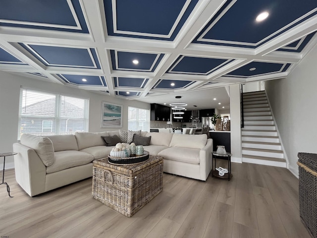 living area with baseboards, beamed ceiling, coffered ceiling, and wood finished floors