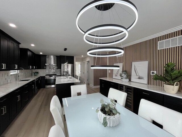 dining room with ornamental molding, recessed lighting, and wood finished floors