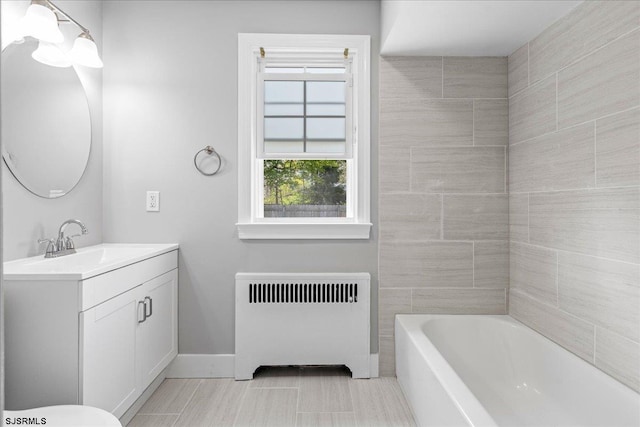 626 1st St, Northfield, NJ 08225 - bathroom featuring a washtub, baseboards, radiator heating unit, and vanity