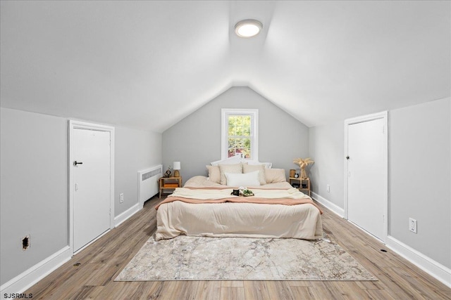 626 1st St, Northfield, NJ 08225 - bedroom featuring baseboards, radiator, lofted ceiling, and wood finished floors