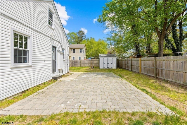 626 1st St, Northfield, NJ 08225 - view of patio / terrace with a fenced backyard, a storage unit, and an outbuilding