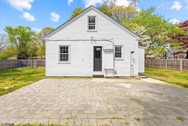 626 1st St, Northfield, NJ 08225 - rear view of house with a fenced backyard, a yard, and a patio area