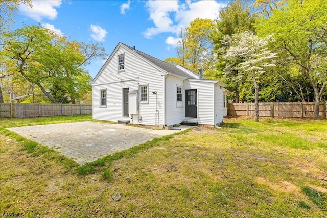 626 1st St, Northfield, NJ 08225 - back of property featuring a lawn, a fenced backyard, and a patio