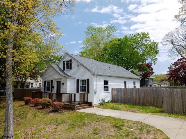 626 1st St, Northfield, NJ 08225 - bungalow-style home featuring fence, a wooden deck, roof with shingles, and a front yard