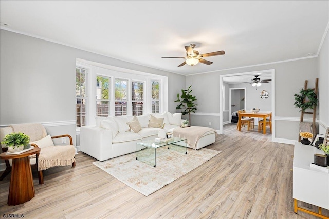 626 1st St, Northfield, NJ 08225 - living room with crown molding, a ceiling fan, light wood-style flooring, and baseboards
