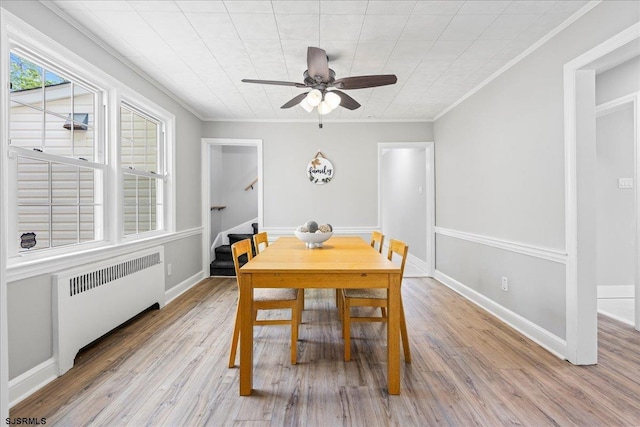 626 1st St, Northfield, NJ 08225 - dining space featuring ornamental molding, stairs, wood finished floors, ceiling fan, and radiator heating unit