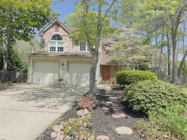 711 Falcon Crest Pl, Smithville, NJ 08205 - view of front facade featuring fence, a garage, concrete driveway, and roof with shingles