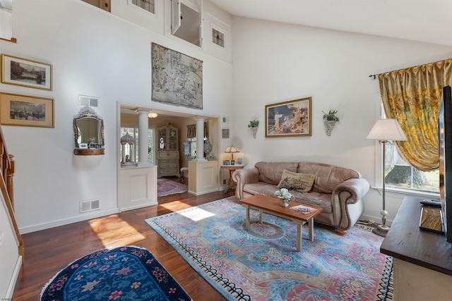 711 Falcon Crest Pl, Smithville, NJ 08205 - living area with wood finished floors, healthy amount of natural light, a high ceiling, ornate columns, and baseboards