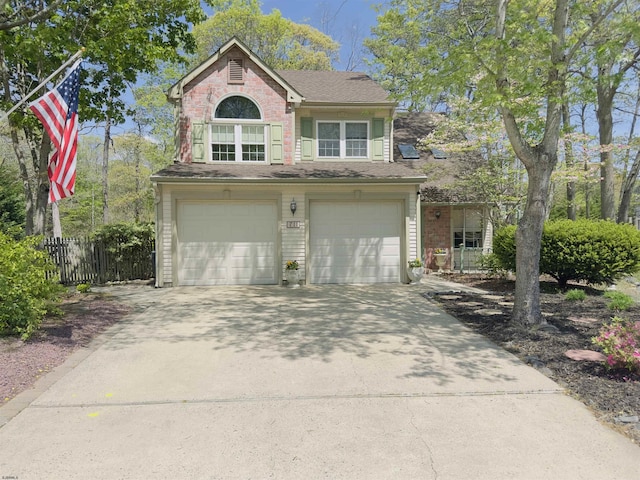 711 Falcon Crest Pl, Smithville, NJ 08205 - traditional-style home with a garage, concrete driveway, fence, and brick siding