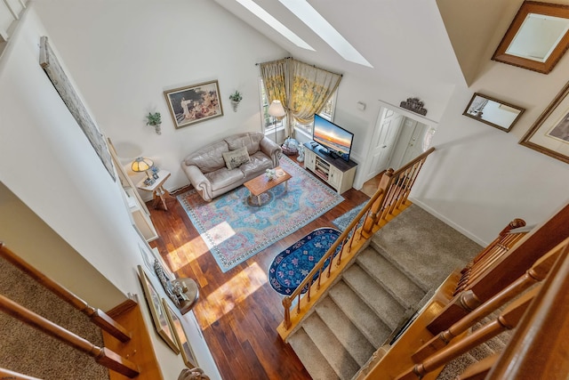 711 Falcon Crest Pl, Smithville, NJ 08205 - stairway featuring a skylight, wood finished floors, vaulted ceiling, and baseboards