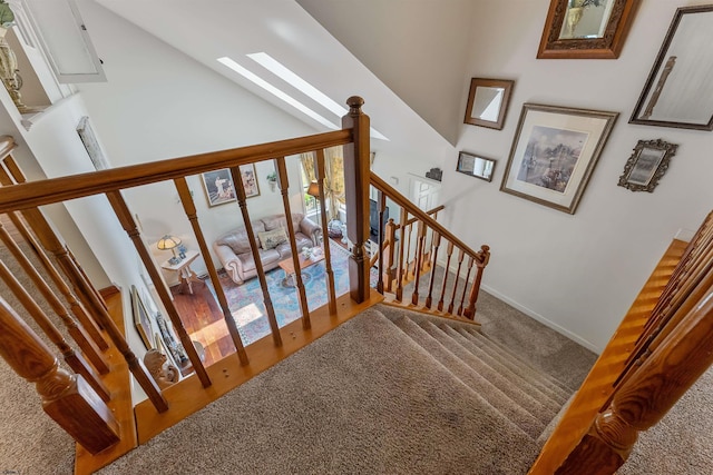711 Falcon Crest Pl, Smithville, NJ 08205 - stairway with carpet floors, high vaulted ceiling, and baseboards