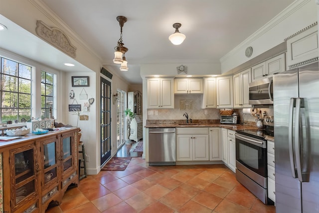 711 Falcon Crest Pl, Smithville, NJ 08205 - kitchen featuring appliances with stainless steel finishes, a sink, ornamental molding, decorative backsplash, and pendant lighting