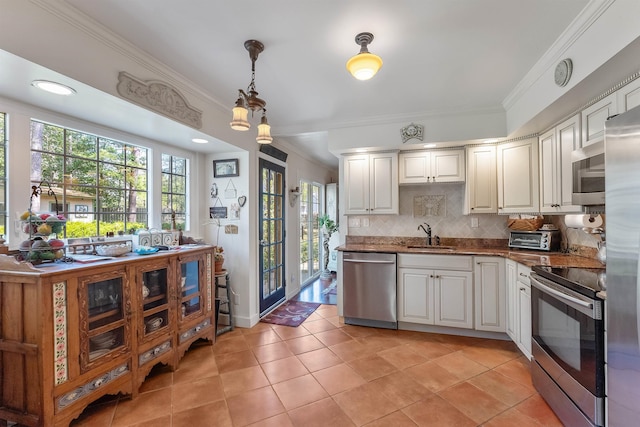 711 Falcon Crest Pl, Smithville, NJ 08205 - kitchen featuring appliances with stainless steel finishes, ornamental molding, a sink, tasteful backsplash, and healthy amount of natural light