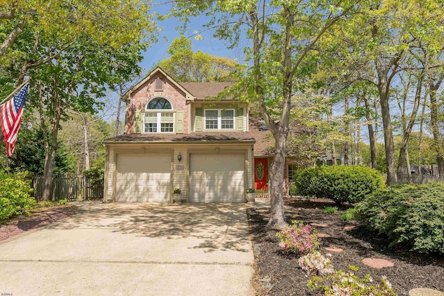 711 Falcon Crest Pl, Smithville, NJ 08205 - traditional-style house featuring a garage, driveway, and fence